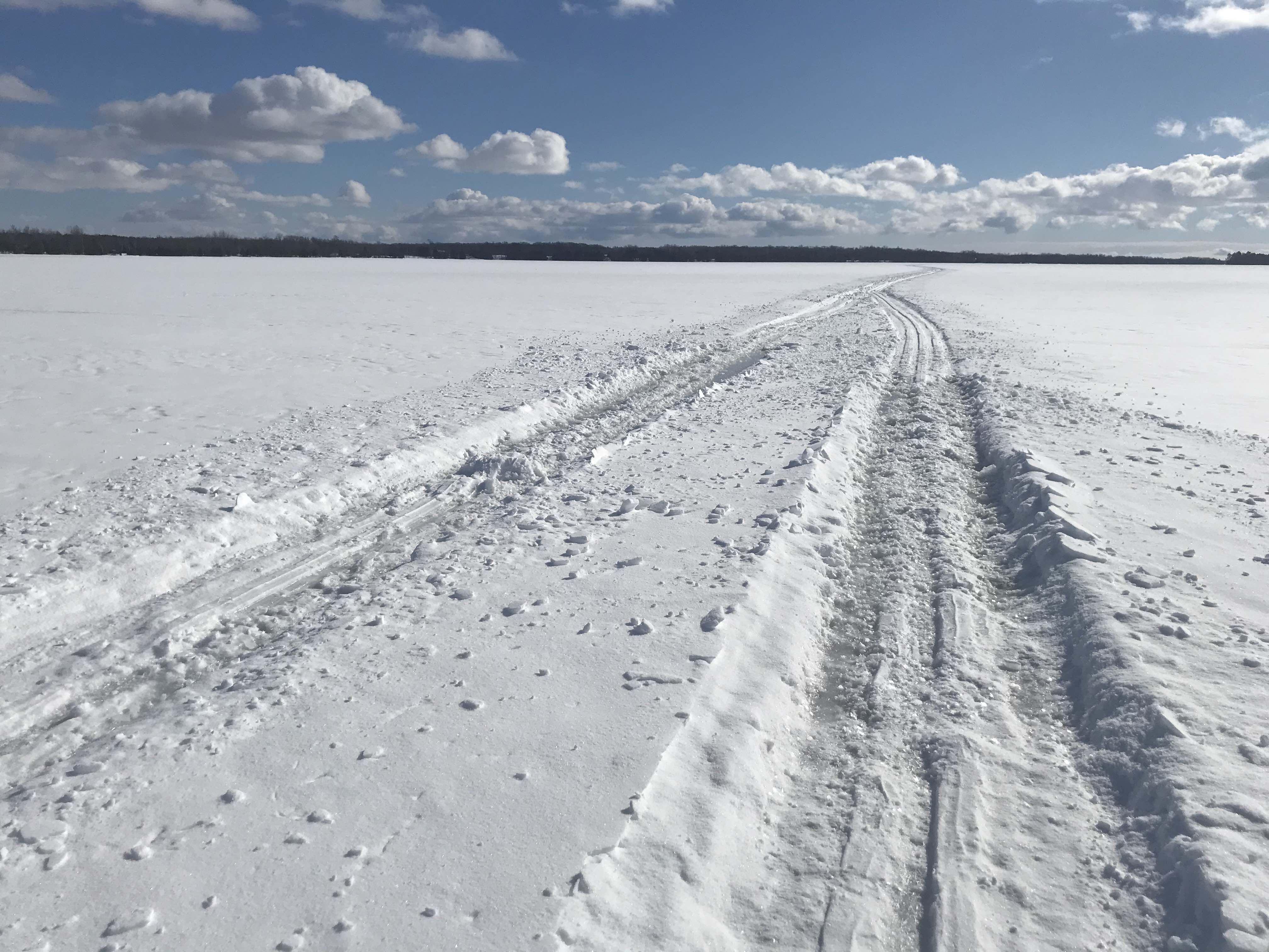 Skiing in snowmobile tracks on a frozen lake